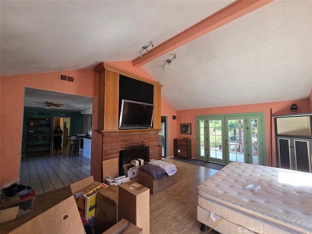 983 Oak St, Costa Mesa, CA 92627 - living area featuring french doors, a ceiling fan, wood finished floors, a fireplace, and track lighting
