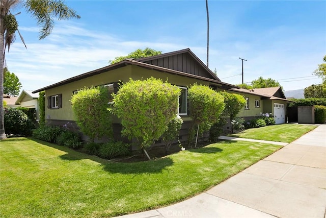 544 N California St, Burbank, CA 91505 - view of property exterior with a lawn, a garage, board and batten siding, and concrete driveway