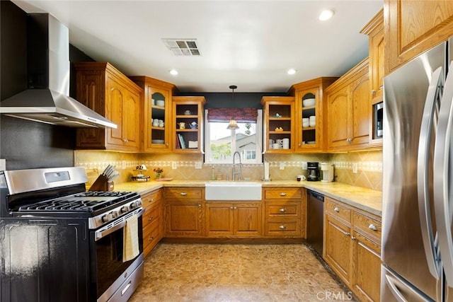 544 N California St, Burbank, CA 91505 - kitchen with appliances with stainless steel finishes, wall chimney exhaust hood, brown cabinetry, glass insert cabinets, and recessed lighting