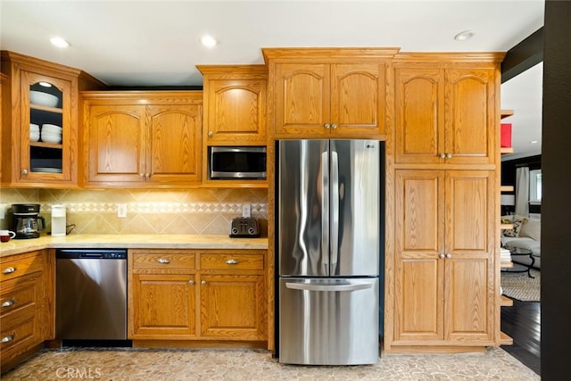 544 N California St, Burbank, CA 91505 - kitchen featuring stainless steel appliances, light countertops, glass insert cabinets, brown cabinetry, and recessed lighting