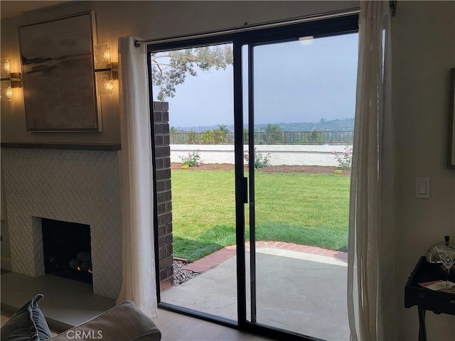 2722 Olympia Dr, Carlsbad, CA 92010 - entryway with a fireplace and light wood-style flooring