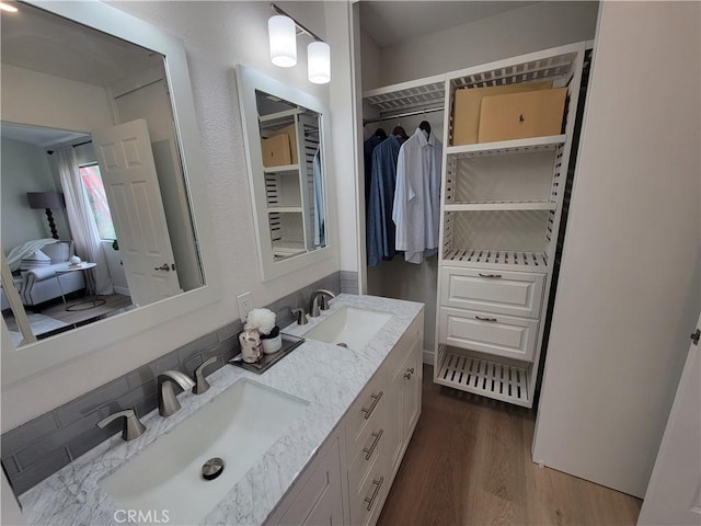 2722 Olympia Dr, Carlsbad, CA 92010 - full bath featuring double vanity, wood finished floors, tasteful backsplash, and a closet