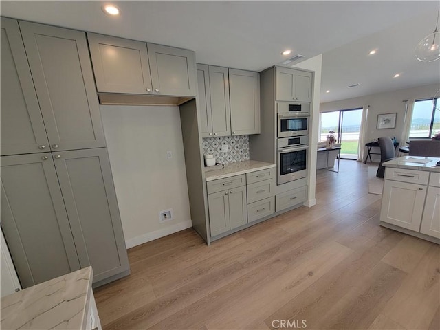 2722 Olympia Dr, Carlsbad, CA 92010 - kitchen featuring gray cabinetry, stainless steel double oven, light wood-style flooring, decorative backsplash, and recessed lighting
