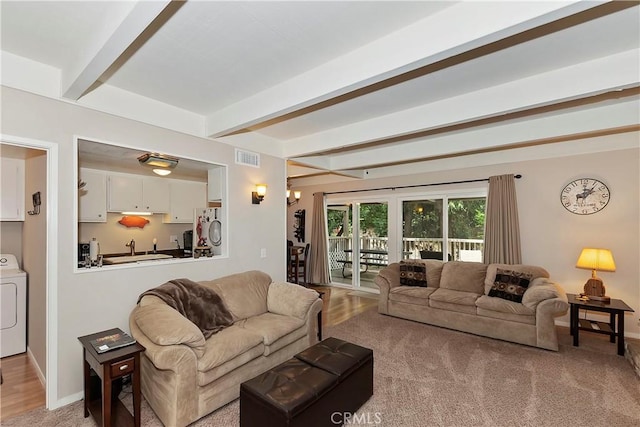 209 Cool Creek Ln Unit 10, Lake Arrowhead, CA 92352 - living area featuring washer / dryer, beamed ceiling, and baseboards