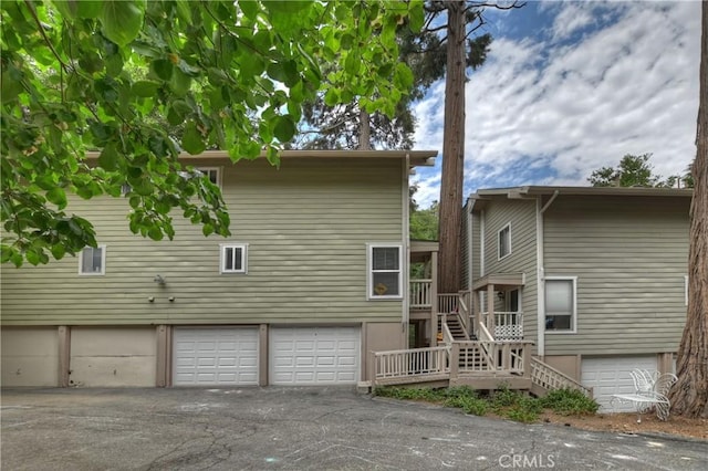 209 Cool Creek Ln Unit 10, Lake Arrowhead, CA 92352 - rear view of property featuring stairway, an attached garage, and asphalt driveway