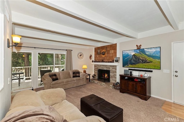 209 Cool Creek Ln Unit 10, Lake Arrowhead, CA 92352 - living area featuring beam ceiling, a stone fireplace, baseboards, and carpet