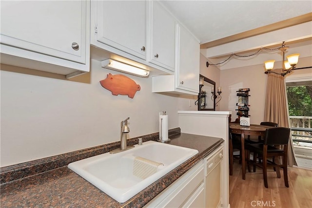209 Cool Creek Ln Unit 10, Lake Arrowhead, CA 92352 - kitchen with a sink, white cabinetry, dark countertops, light wood-style floors, and a chandelier