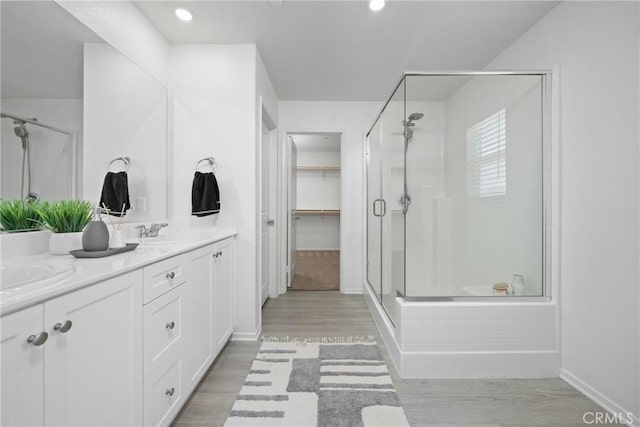 1330 Carolina Ct, Hemet, CA 92543 - full bath featuring a stall shower, baseboards, double vanity, wood finished floors, and a walk in closet