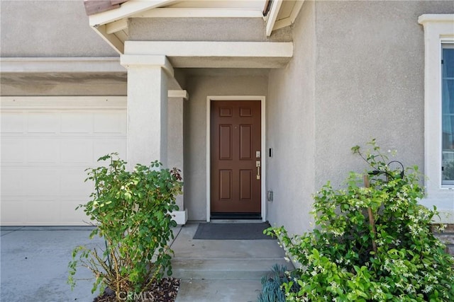 1330 Carolina Ct, Hemet, CA 92543 - doorway to property featuring stucco siding and an attached garage
