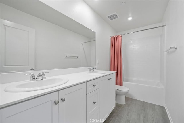1330 Carolina Ct, Hemet, CA 92543 - full bath with toilet, double vanity, shower / bath combo with shower curtain, and wood finished floors