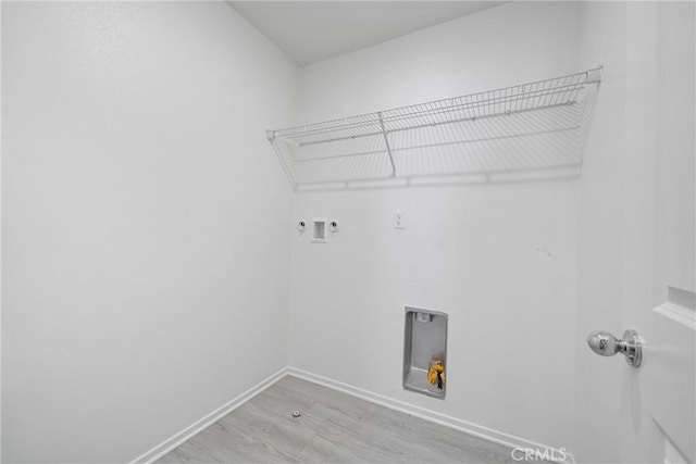 1330 Carolina Ct, Hemet, CA 92543 - laundry area with electric dryer hookup, light wood-type flooring, hookup for a washing machine, baseboards, and gas dryer hookup