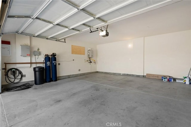 1330 Carolina Ct, Hemet, CA 92543 - garage featuring a garage door opener and tankless water heater