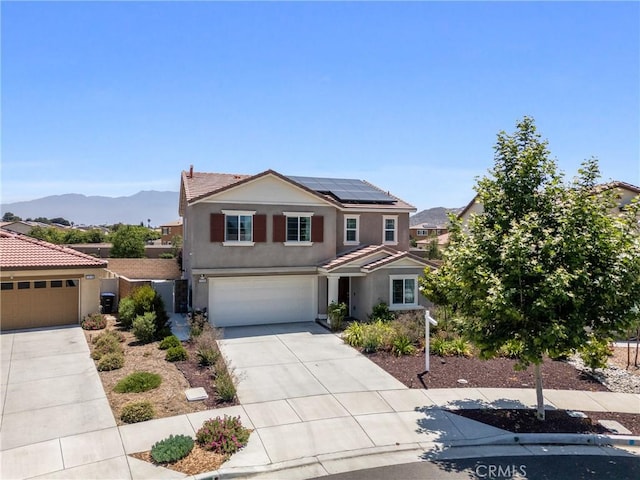 1330 Carolina Ct, Hemet, CA 92543 - traditional-style house with concrete driveway, roof mounted solar panels, stucco siding, a tile roof, and an attached garage