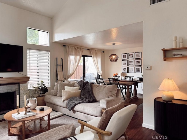 543 W Puente St Unit 3, Covina, CA 91722 - living room featuring wood finished floors, a fireplace, a towering ceiling, and baseboards