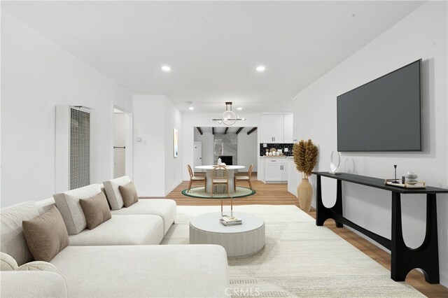 611 S Thorson Ave, Compton, CA 90221 - living area with a heating unit, light wood finished floors, recessed lighting, and a chandelier