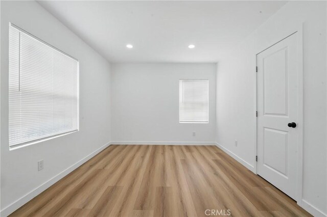 611 S Thorson Ave, Compton, CA 90221 - unfurnished bedroom with light wood-style floors, baseboards, recessed lighting, and multiple windows