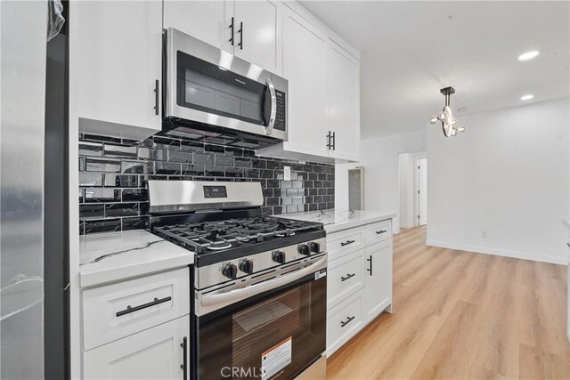 611 S Thorson Ave, Compton, CA 90221 - kitchen with stainless steel appliances, tasteful backsplash, white cabinets, and recessed lighting