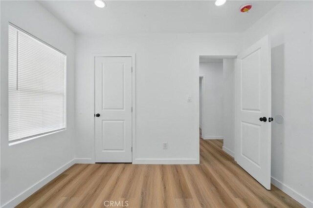 611 S Thorson Ave, Compton, CA 90221 - unfurnished bedroom with light wood-type flooring, baseboards, and recessed lighting