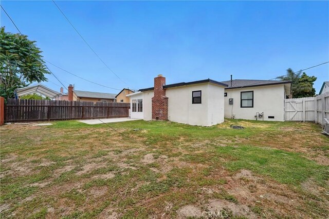 611 S Thorson Ave, Compton, CA 90221 - back of property with stucco siding and a patio