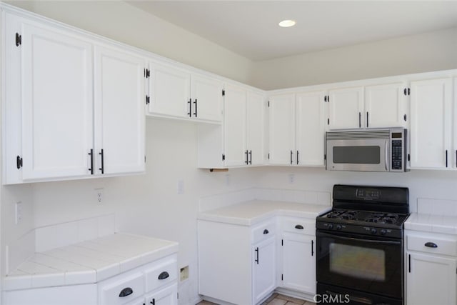27292 Eagles Nest Dr, Corona, CA 92883 - kitchen featuring stainless steel microwave, black gas range, white cabinets, recessed lighting, and tile counters