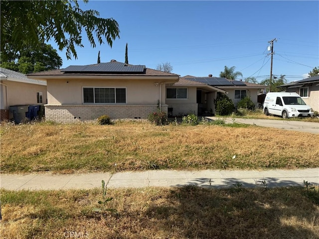 4115 E Dayton Ave, Fresno, CA 93726 - single story home featuring roof mounted solar panels, brick siding, and stucco siding