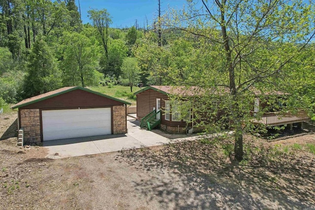 34387 Wolahi Rd, Julian, CA 92036 - view of front of home with a garage, an outbuilding, stone siding, and a view of trees