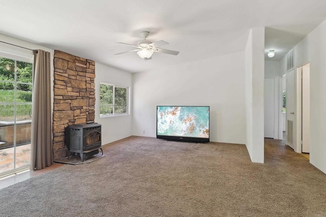 34387 Wolahi Rd, Julian, CA 92036 - unfurnished living room with plenty of natural light, a wood stove, ceiling fan, and carpet flooring