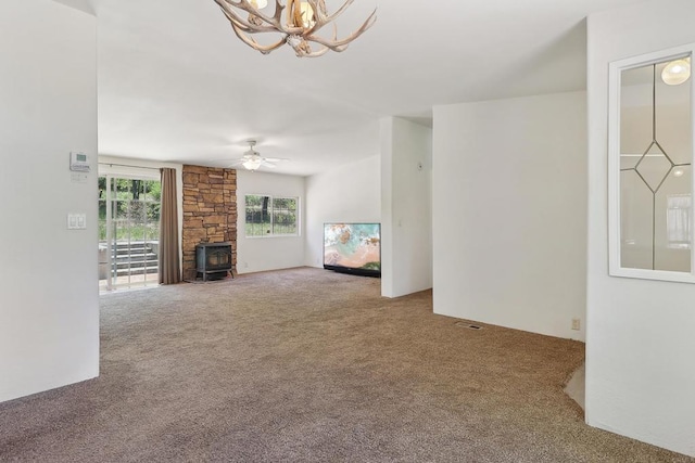 34387 Wolahi Rd, Julian, CA 92036 - unfurnished living room with carpet, a wood stove, a chandelier, and ceiling fan