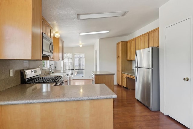 34387 Wolahi Rd, Julian, CA 92036 - kitchen with stainless steel appliances, a sink, a kitchen island, backsplash, and dark wood-type flooring