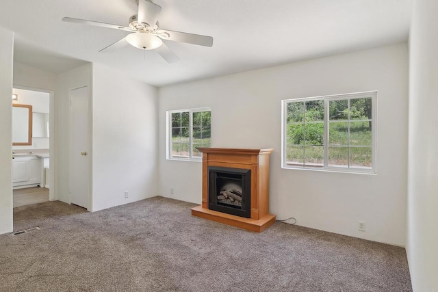 34387 Wolahi Rd, Julian, CA 92036 - unfurnished living room featuring carpet floors, a ceiling fan, and a fireplace with raised hearth