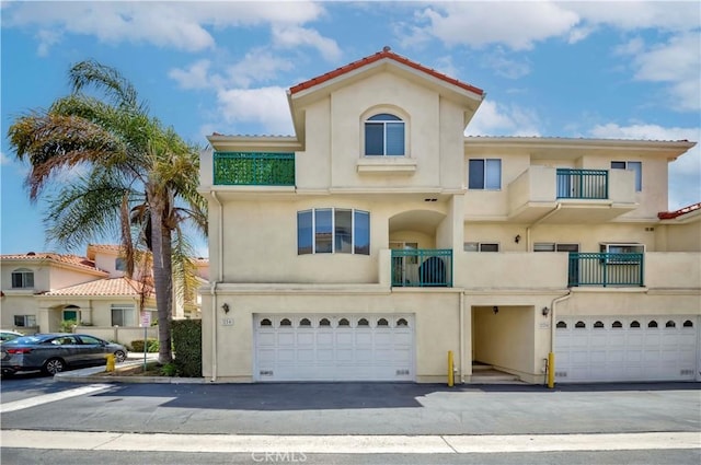 4489 Spencer St Unit 224, Torrance, CA 90503 - mediterranean / spanish home featuring stucco siding, a garage, and a tile roof