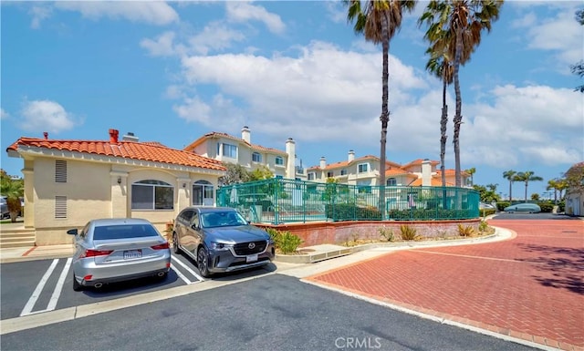 4489 Spencer St Unit 224, Torrance, CA 90503 - view of building exterior featuring uncovered parking and a residential view