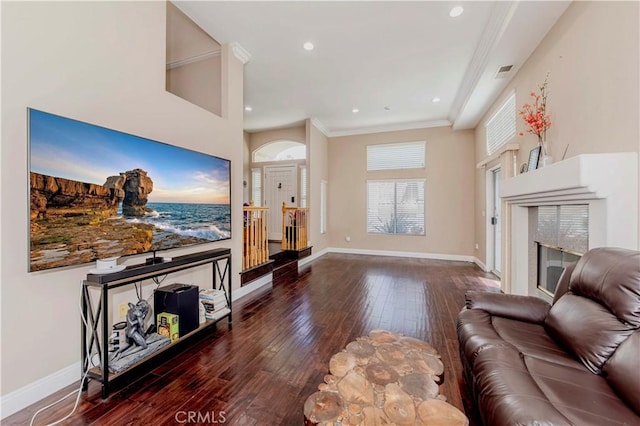 4489 Spencer St Unit 224, Torrance, CA 90503 - living area featuring hardwood / wood-style flooring, baseboards, ornamental molding, a tiled fireplace, and recessed lighting