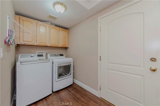 4489 Spencer St Unit 224, Torrance, CA 90503 - laundry area with washer and clothes dryer, cabinet space, baseboards, and dark wood finished floors