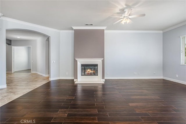 967 Hidden Oaks, Beaumont, CA 92223 - unfurnished living room with arched walkways, ceiling fan, wood finished floors, baseboards, and crown molding