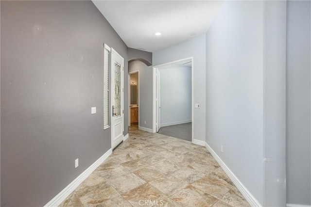 967 Hidden Oaks, Beaumont, CA 92223 - hall featuring arched walkways, baseboards, and stone finish flooring