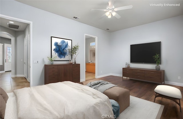 967 Hidden Oaks, Beaumont, CA 92223 - bedroom featuring wood finished floors, arched walkways, baseboards, and connected bathroom