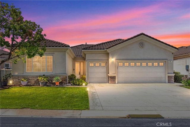 967 Hidden Oaks, Beaumont, CA 92223 - view of front facade featuring a garage, stone siding, stucco siding, and driveway