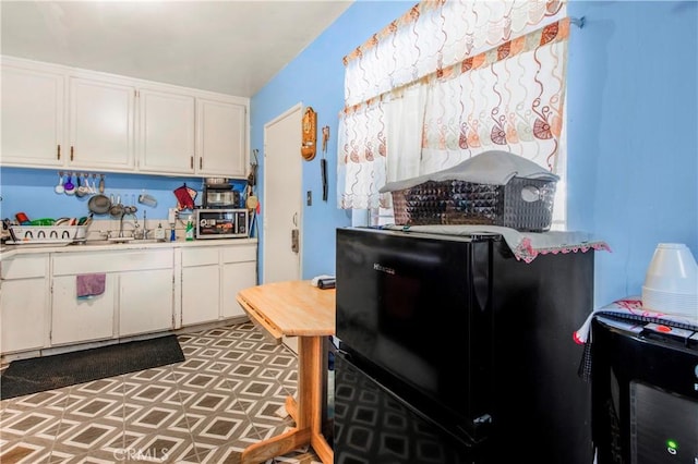 10636 Wolfe Ave, Riverside, CA 92505 - kitchen featuring a sink, white cabinetry, light countertops, and tile patterned floors