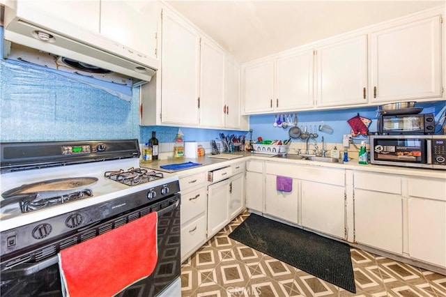 10636 Wolfe Ave, Riverside, CA 92505 - kitchen featuring gas range, under cabinet range hood, a sink, stainless steel microwave, and white cabinetry