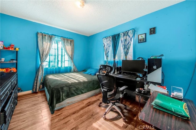 10636 Wolfe Ave, Riverside, CA 92505 - bedroom featuring wood finished floors, a textured ceiling, and an office area
