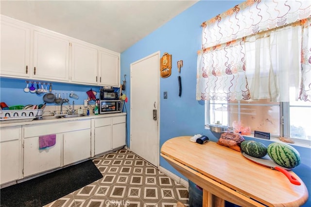 10636 Wolfe Ave, Riverside, CA 92505 - kitchen with a sink, white cabinets, and light countertops