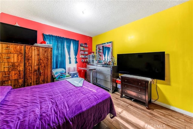 10636 Wolfe Ave, Riverside, CA 92505 - bedroom featuring a textured ceiling and wood finished floors
