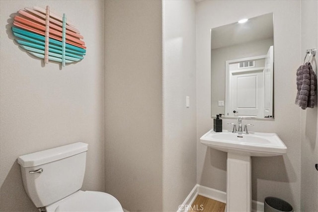 3516 Brody Way, Oceanside, CA 92056 - bathroom with toilet, baseboards, wood finished floors, and a sink