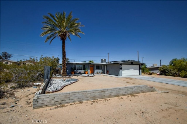 5536 Cahuilla Ave Unit 29, Palms, CA 92277 - ranch-style home featuring driveway, an attached garage, and solar panels
