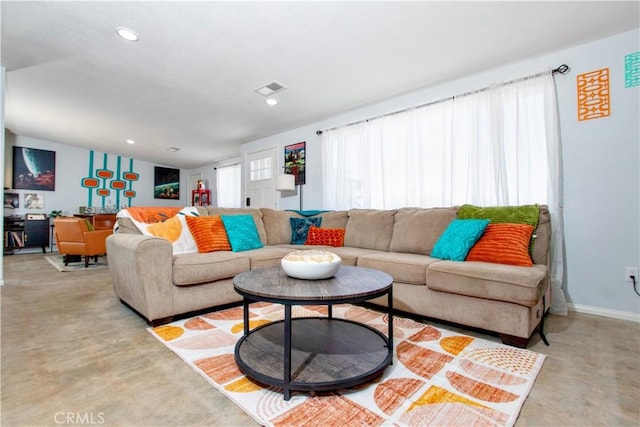 5536 Cahuilla Ave Unit 29, Palms, CA 92277 - living area with finished concrete flooring, recessed lighting, and baseboards