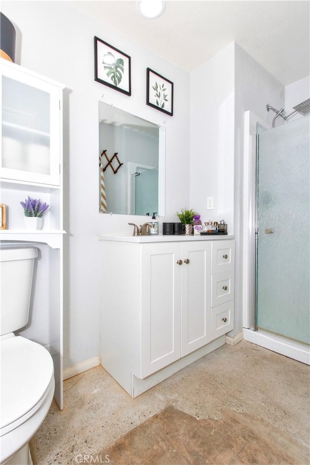 5536 Cahuilla Ave Unit 29, Palms, CA 92277 - bathroom with baseboards, toilet, an enclosed shower, and vanity