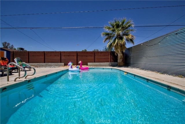 5536 Cahuilla Ave Unit 29, Palms, CA 92277 - view of swimming pool featuring a fenced backyard and a patio