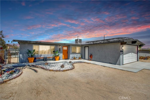 5536 Cahuilla Ave Unit 29, Palms, CA 92277 - view of front of house featuring stucco siding, a garage, and driveway