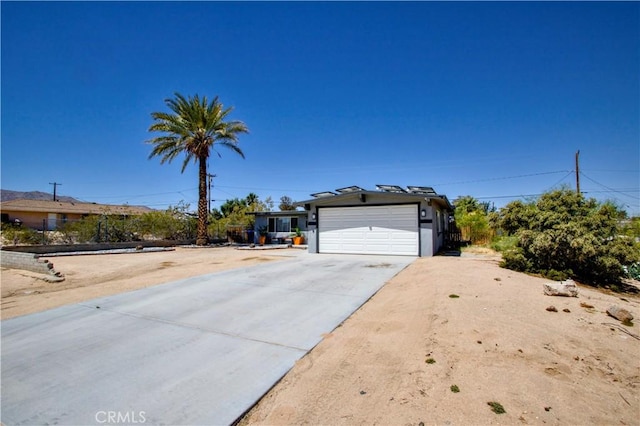 5536 Cahuilla Ave Unit 29, Palms, CA 92277 - view of front of home featuring driveway and a garage